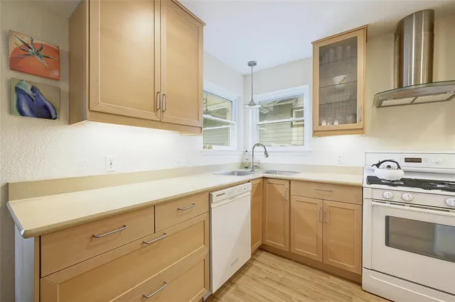 a kitchen with white cabinets and white appliances