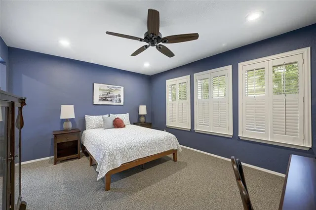 a bedroom with a bed and a large window