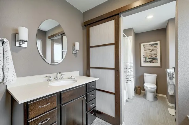 a bathroom with a sink vanity and a mirror