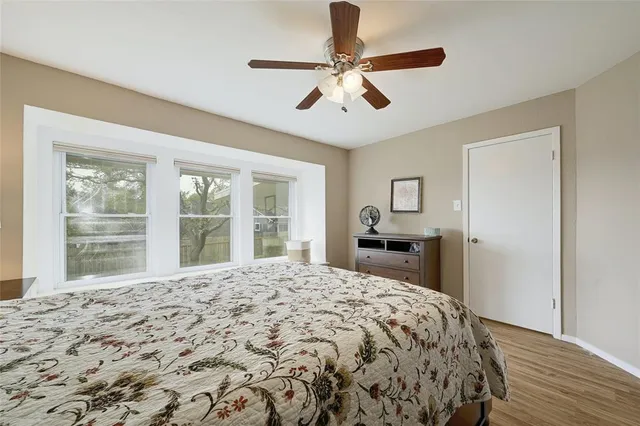 a bedroom with a large bed and a window