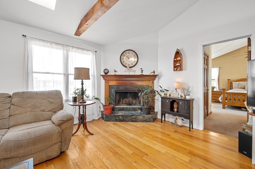 25 Bates Grove Road Webster, MA 01570 - Photo 13 of 42 a living room with furniture a fireplace and a large window
