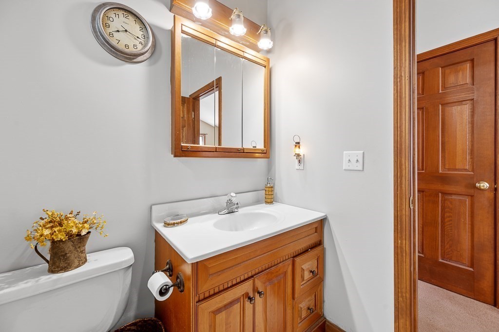25 Bates Grove Road Webster, MA 01570 - Photo 17 of 42 a bathroom with a toilet sink vanity and mirror