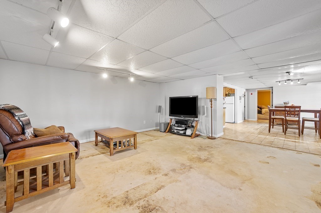 25 Bates Grove Road Webster, MA 01570 - Photo 26 of 42 a living room with furniture and a flat screen tv