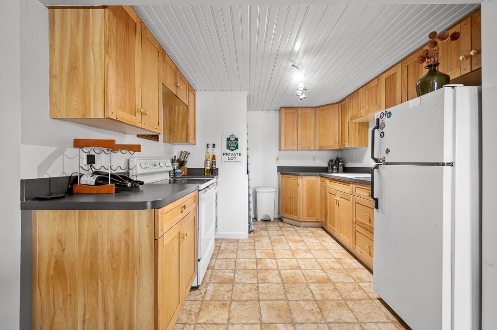 25 Bates Grove Road Webster, MA 01570 - Photo 28 of 42 a kitchen with a refrigerator a sink and cabinets