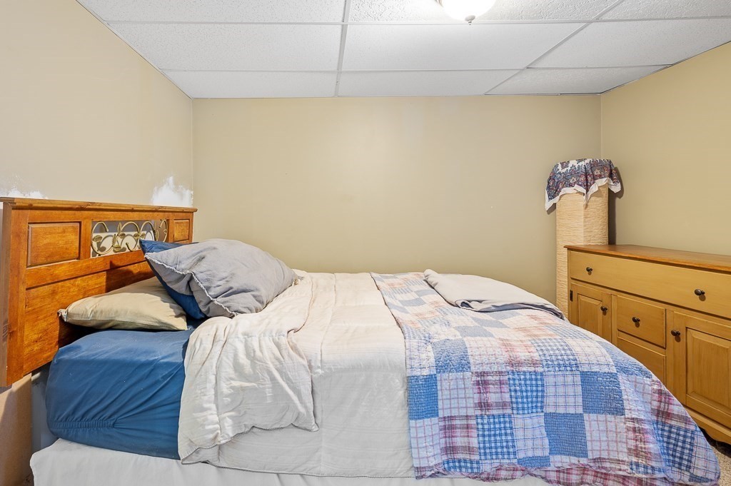 25 Bates Grove Road Webster, MA 01570 - Photo 33 of 42 a bedroom with a bed and a mirror