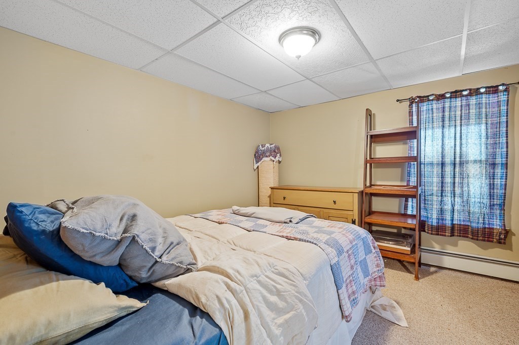 25 Bates Grove Road Webster, MA 01570 - Photo 34 of 42 a bedroom with a bed and a chair