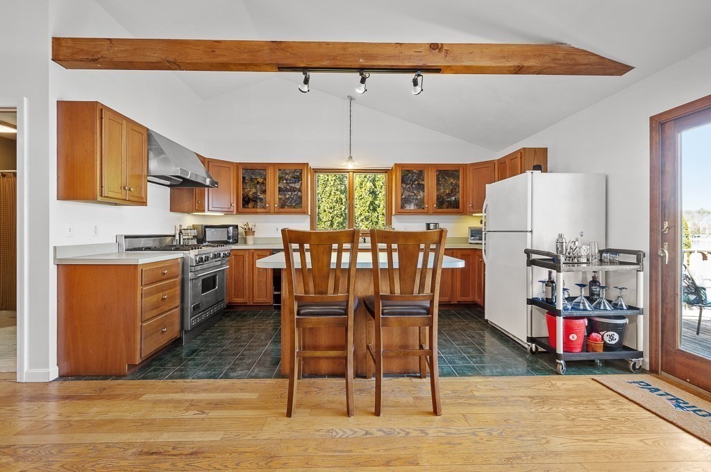25 Bates Grove Road Webster, MA 01570 - Photo 7 of 42 a kitchen with stainless steel appliances granite countertop a stove a sink dishwasher and a refrigerator with wooden cabinets