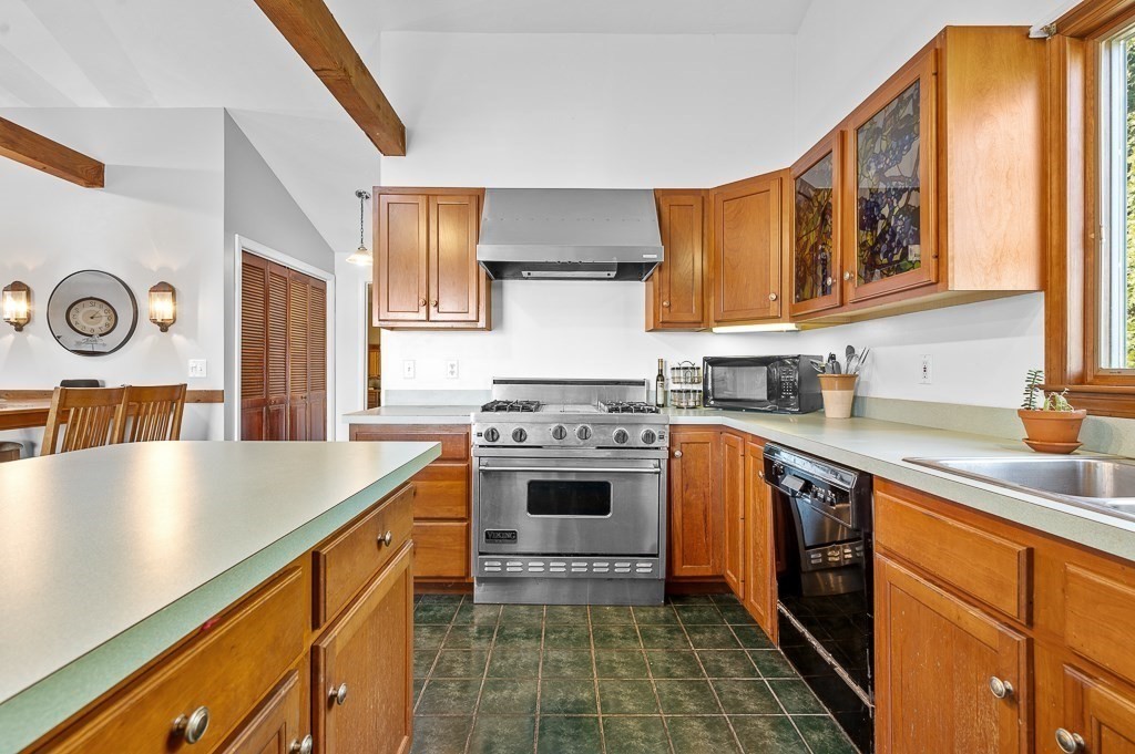 25 Bates Grove Road Webster, MA 01570 - Photo 8 of 42 a kitchen with stainless steel appliances granite countertop a stove a sink and a refrigerator