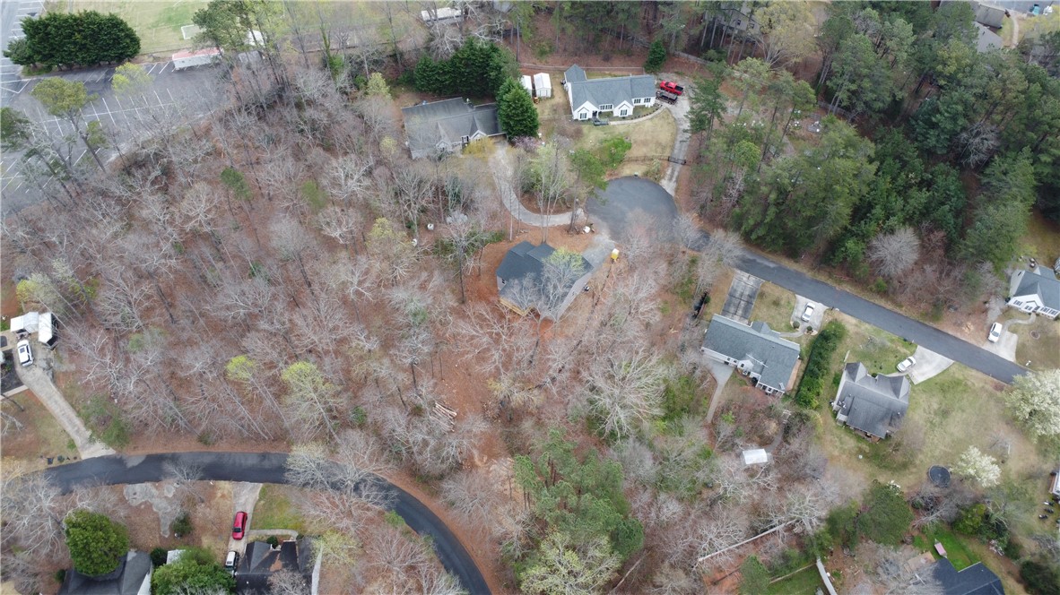 This expansive property offers a peaceful retreat with mature trees and ample space for outdoor living.