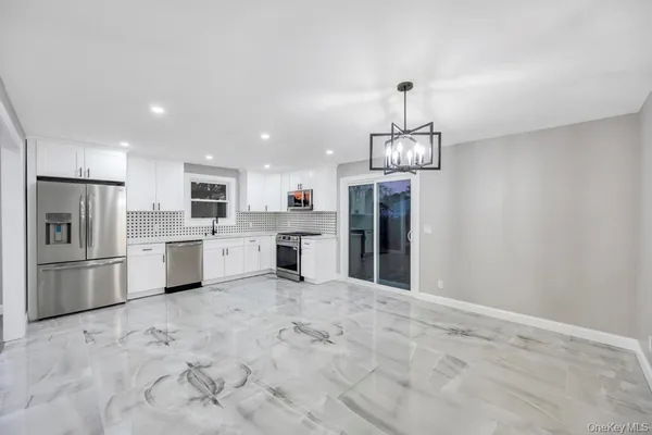 a kitchen with stainless steel appliances granite countertop a refrigerator sink and cabinets
