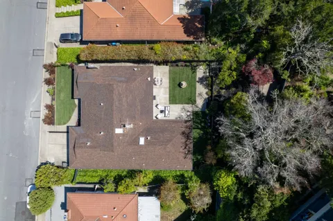an aerial view of a house with a garden and a yard