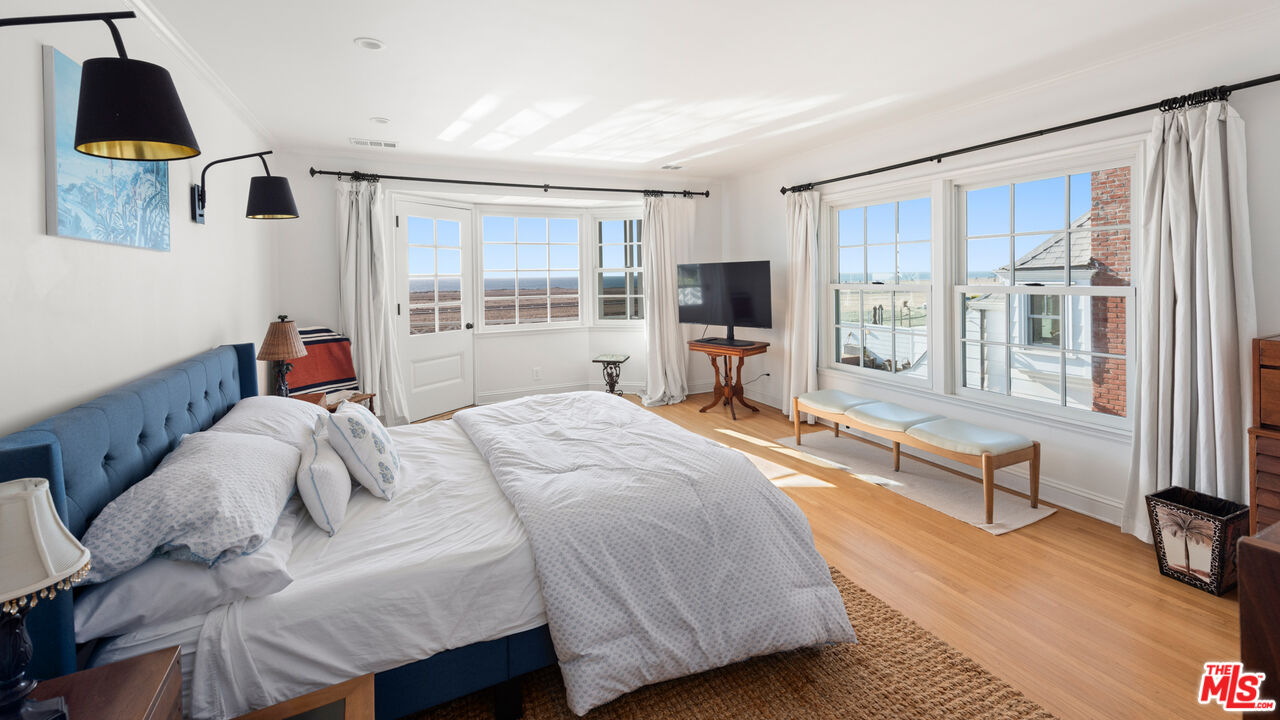 605 Palisades Beach Road Santa Monica, CA 90402 - Photo 30 of 33 a bedroom with a bed and glass windows
