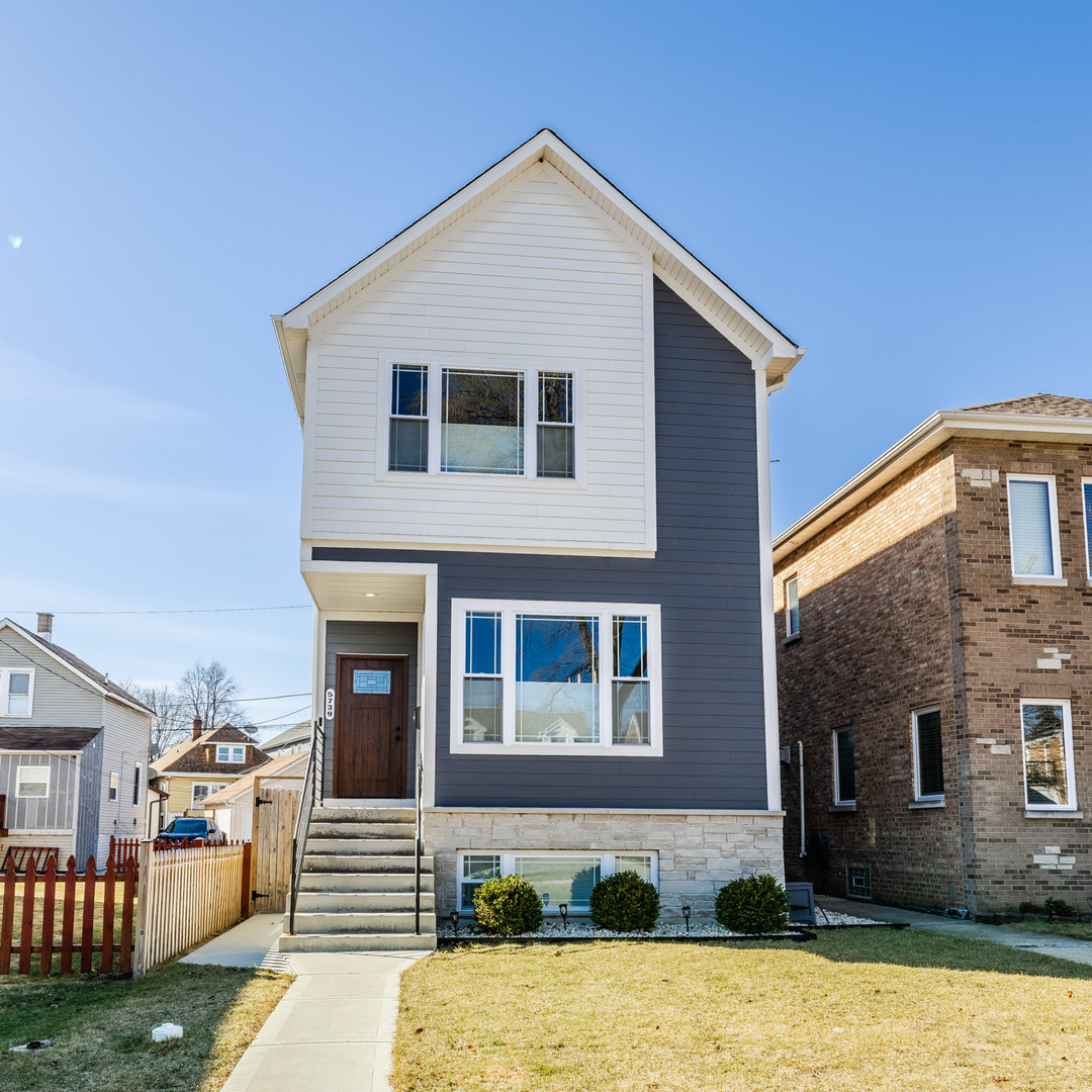 5739 West Grover Street Chicago, IL 60630 - Photo 1 of 38 a front view of a house with a yard and garage