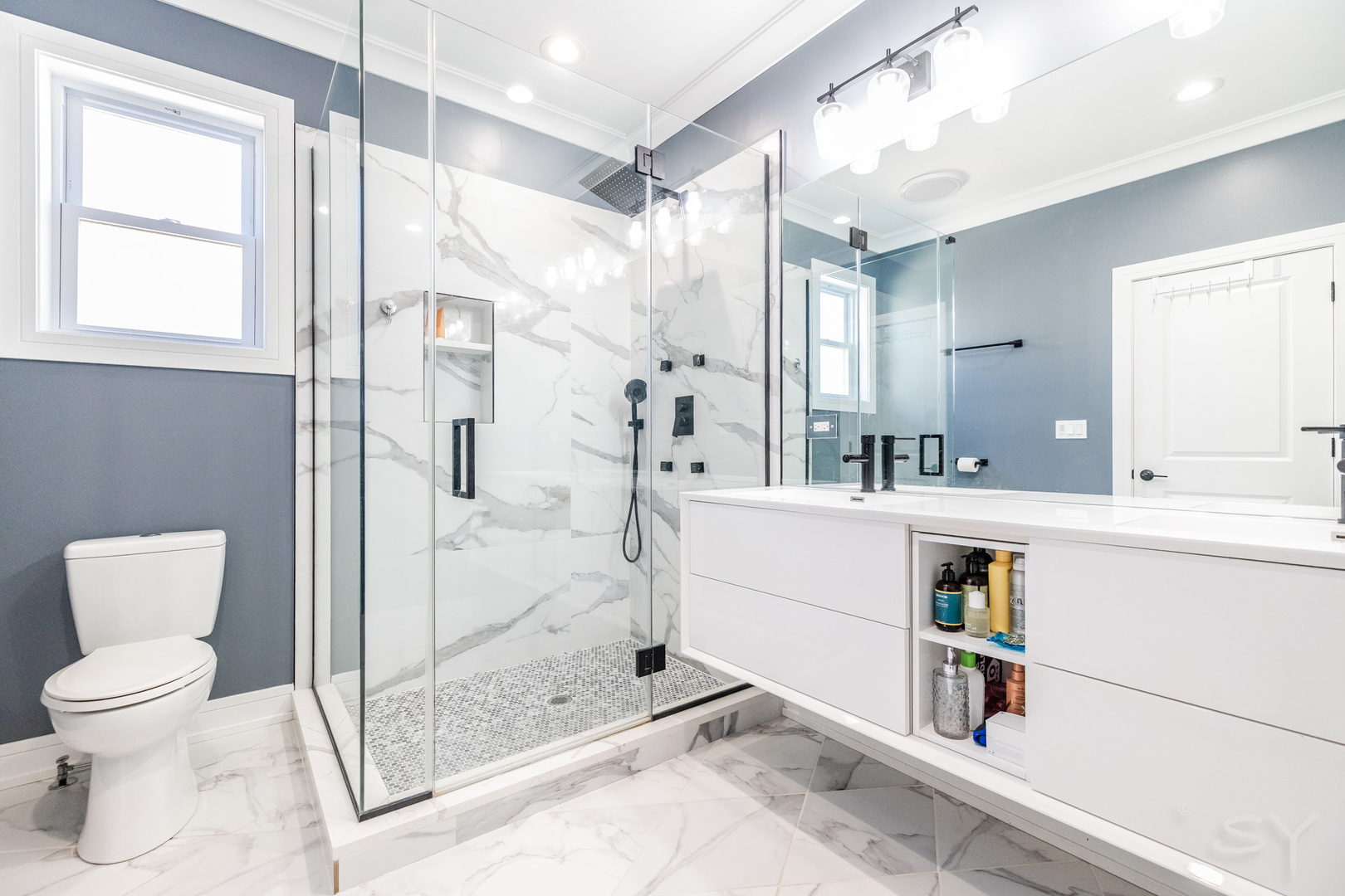 5739 West Grover Street Chicago, IL 60630 - Photo 18 of 38 a bathroom with a sink mirror toilet and shower