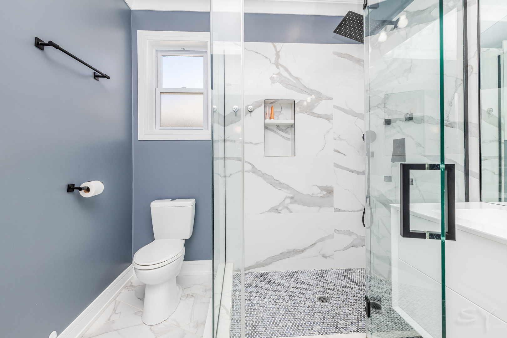 5739 West Grover Street Chicago, IL 60630 - Photo 19 of 38 a white toilet sitting next to a bathroom sink
