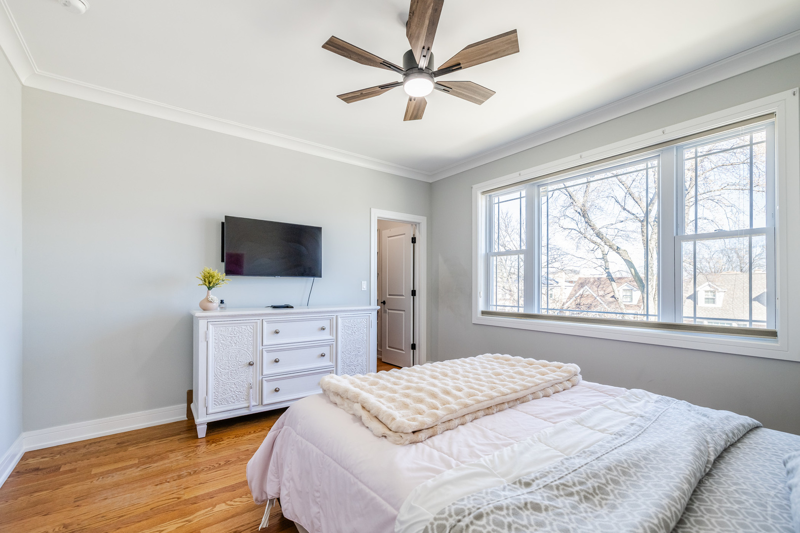 5739 West Grover Street Chicago, IL 60630 - Photo 22 of 38 a bedroom with a bed and a flat screen tv