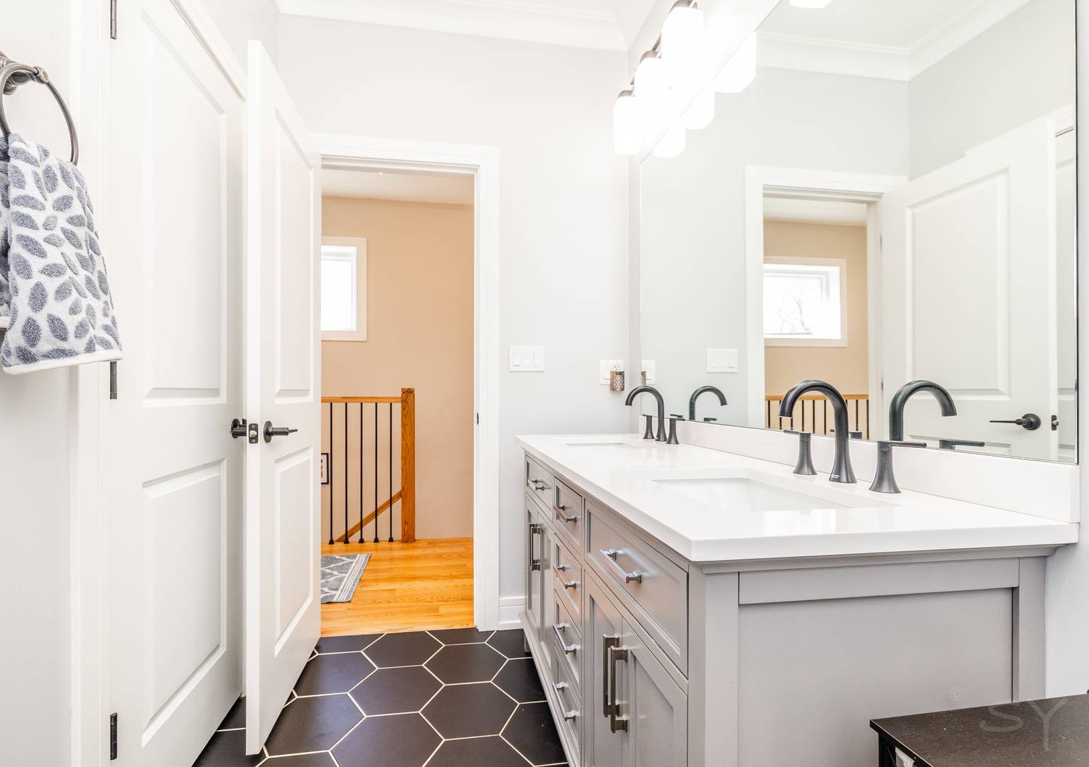 5739 West Grover Street Chicago, IL 60630 - Photo 26 of 38 a bathroom with a double vanity sink and a mirror