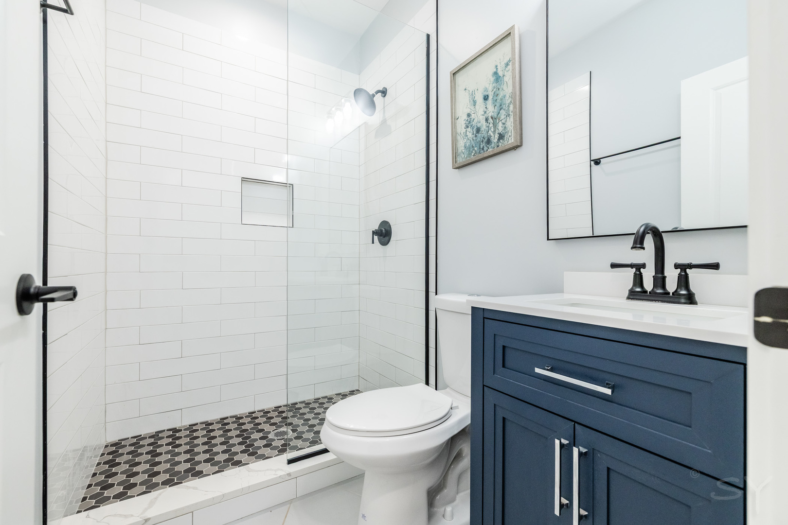 5739 West Grover Street Chicago, IL 60630 - Photo 30 of 38 a bathroom with a sink a toilet and shower
