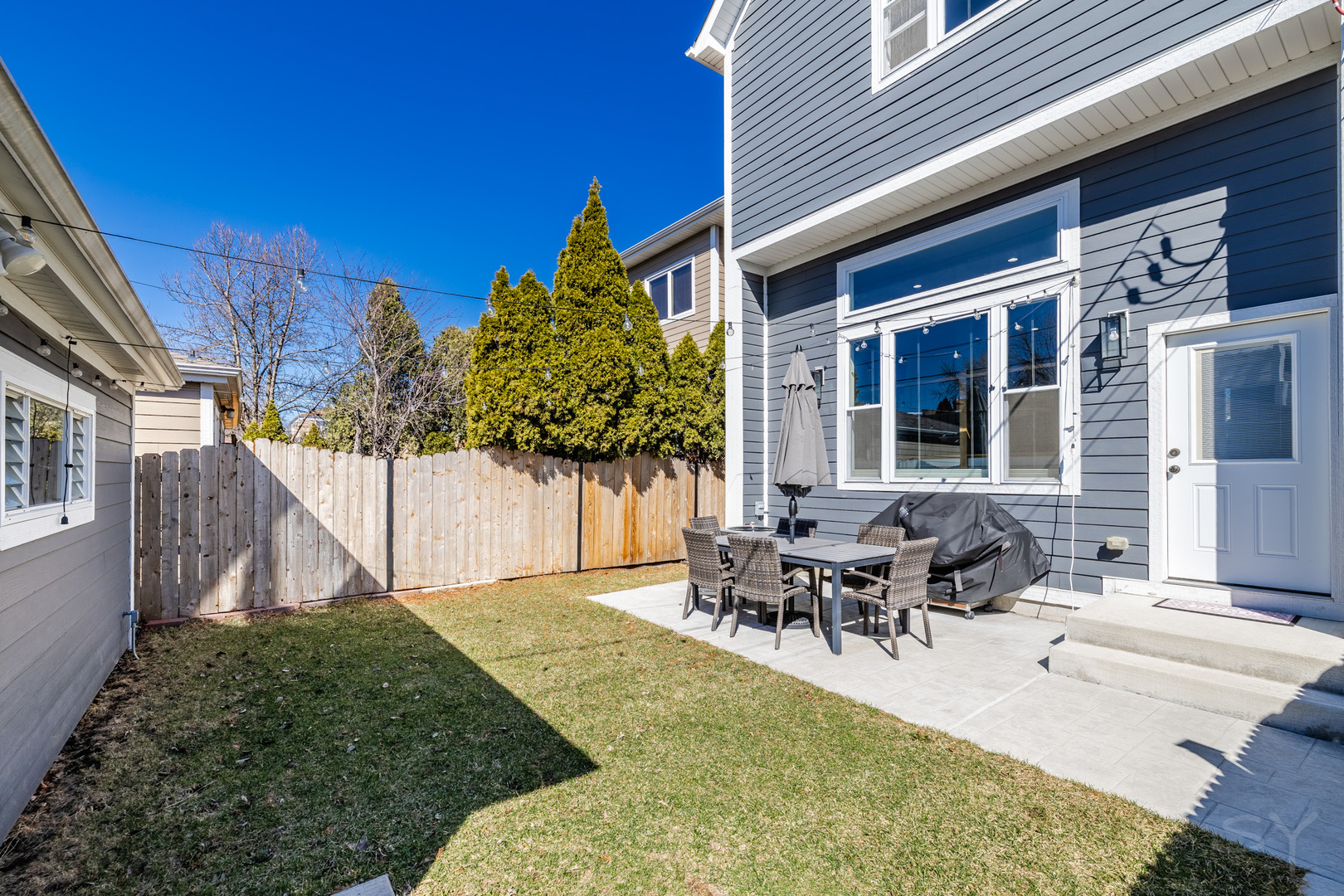 5739 West Grover Street Chicago, IL 60630 - Photo 32 of 38 a view of a house with backyard and sitting area