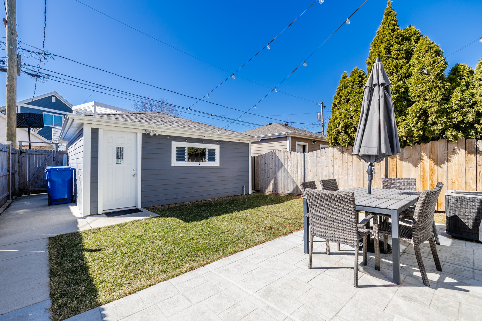 5739 West Grover Street Chicago, IL 60630 - Photo 34 of 38 a view of a backyard with table and chairs with wooden fence