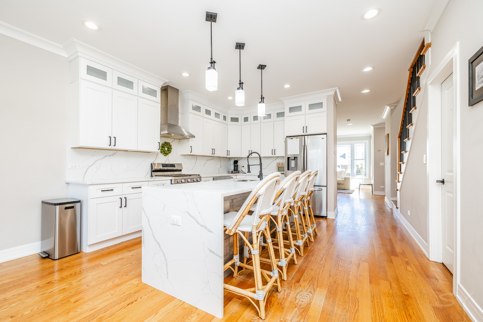 5739 West Grover Street Chicago, IL 60630 - Photo 8 of 38 a kitchen with stainless steel appliances kitchen island granite countertop a refrigerator a sink dishwasher and white cabinets with wooden floor