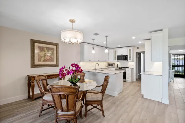 a kitchen with stainless steel appliances granite countertop a stove top oven a sink and a microwave