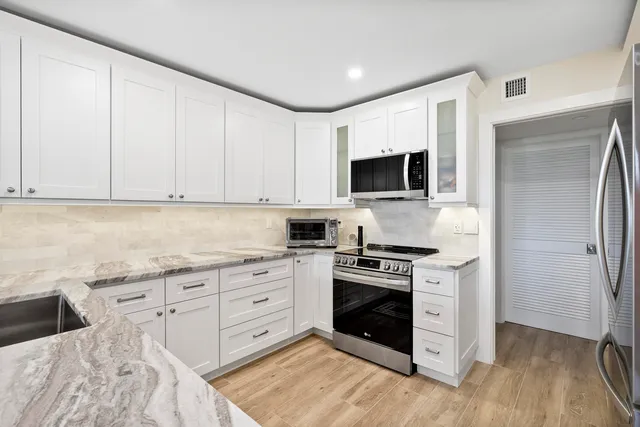 a kitchen with a sink stove and cabinets