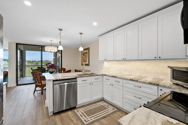 a kitchen with a refrigerator and a stove top oven