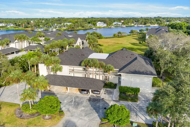 an aerial view of residential houses with outdoor space and river