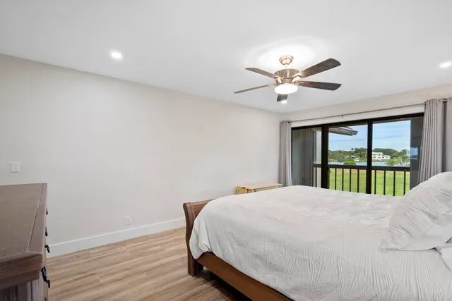 a spacious bedroom with a bed and a chandelier
