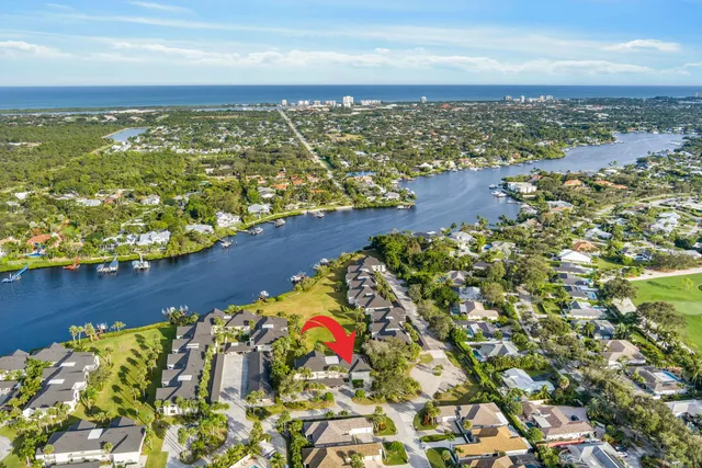 an aerial view of residential building and lake