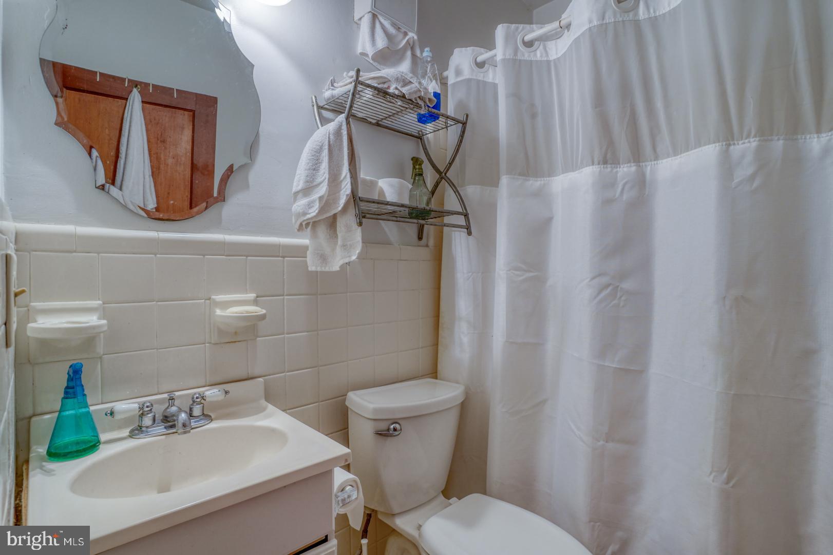 4096 Main Street Trappe, MD 21673 - Photo 42 of 70 a bathroom with a sink a toilet and a mirror