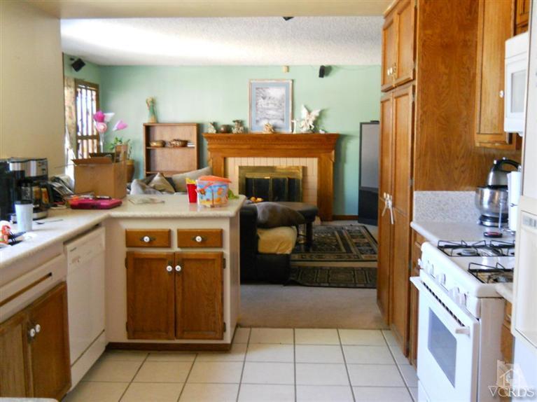 1740 Rivas Lane Oxnard, CA 93035 - Photo 7 of 30 a kitchen with a stove and a refrigerator