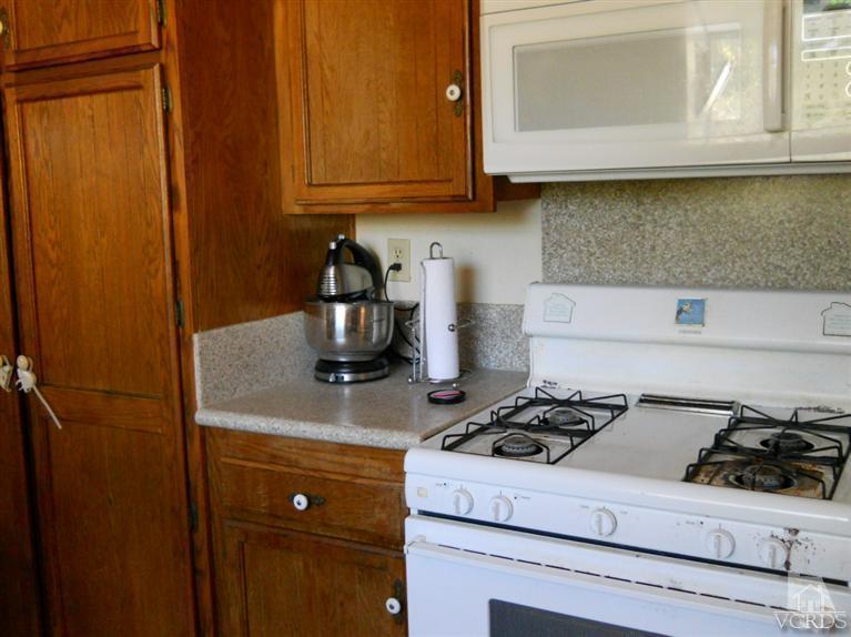 1740 Rivas Lane Oxnard, CA 93035 - Photo 8 of 30 a kitchen with a stove and a microwave