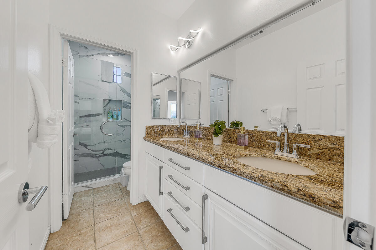 84325 Canzone Drive Indio, CA 92203 - Photo 20 of 53 a bathroom with a granite countertop sink and a mirror