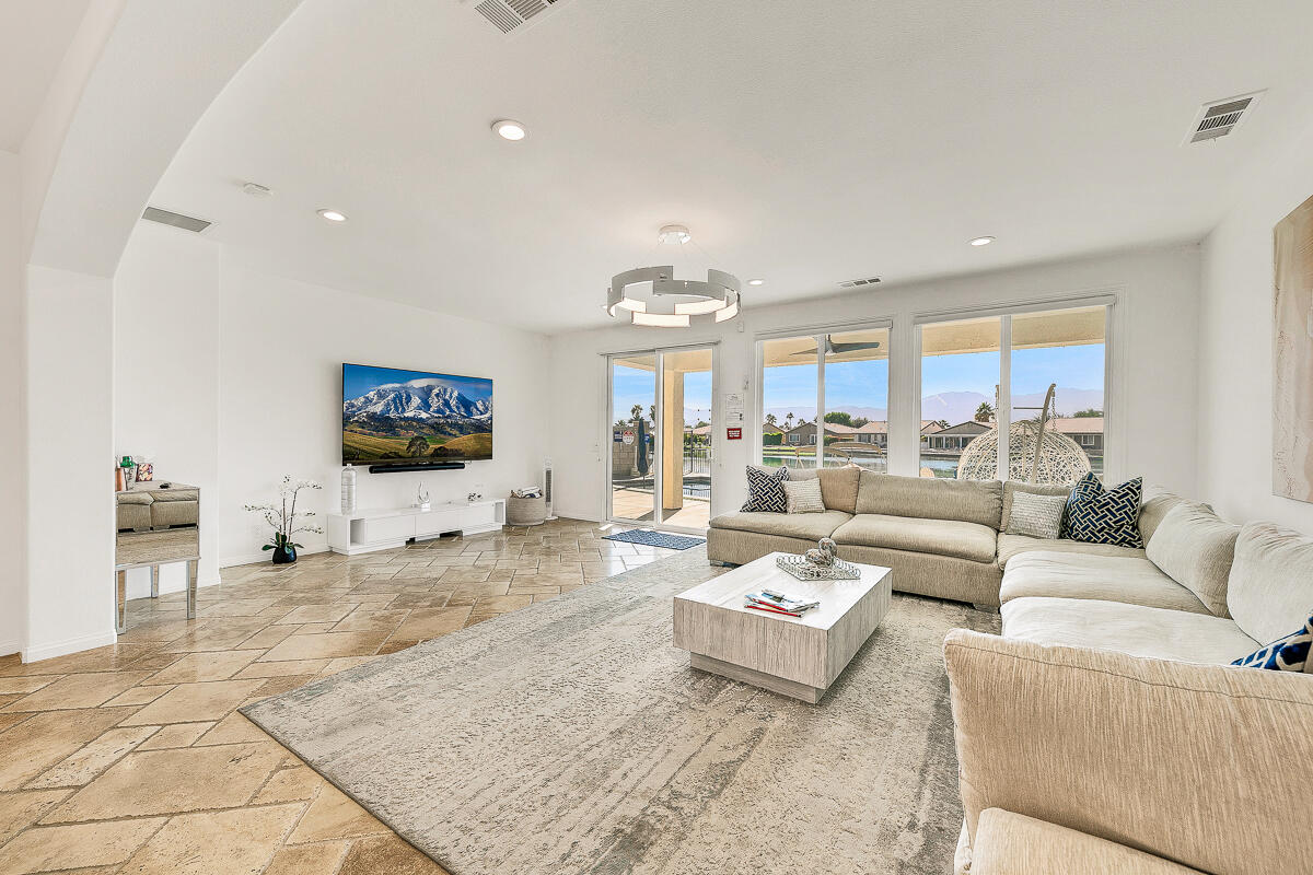 84325 Canzone Drive Indio, CA 92203 - Photo 2 of 53 a living room with furniture and a flat screen tv