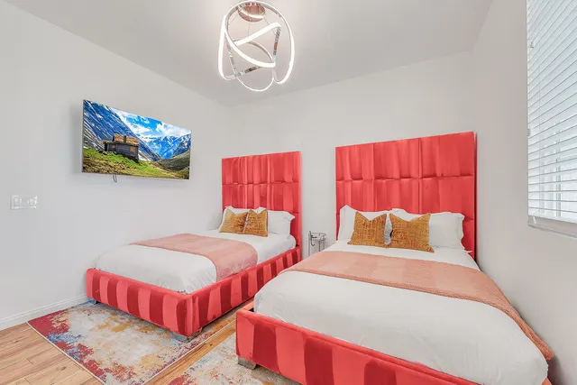 a bedroom with a bed and a chandelier