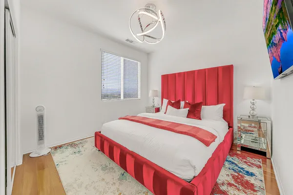 a bedroom with a bed and a painting on the wall