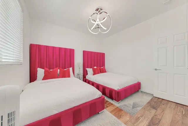 a bedroom with a bed and a chandelier