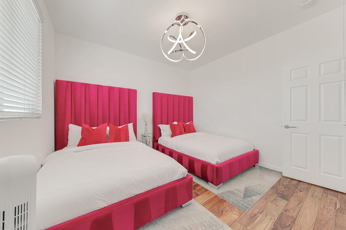 84325 Canzone Drive Indio, CA 92203 - Photo 26 of 53 a bedroom with two beds and a chandelier