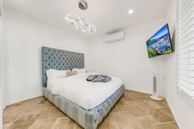 a bedroom with a bed and a table