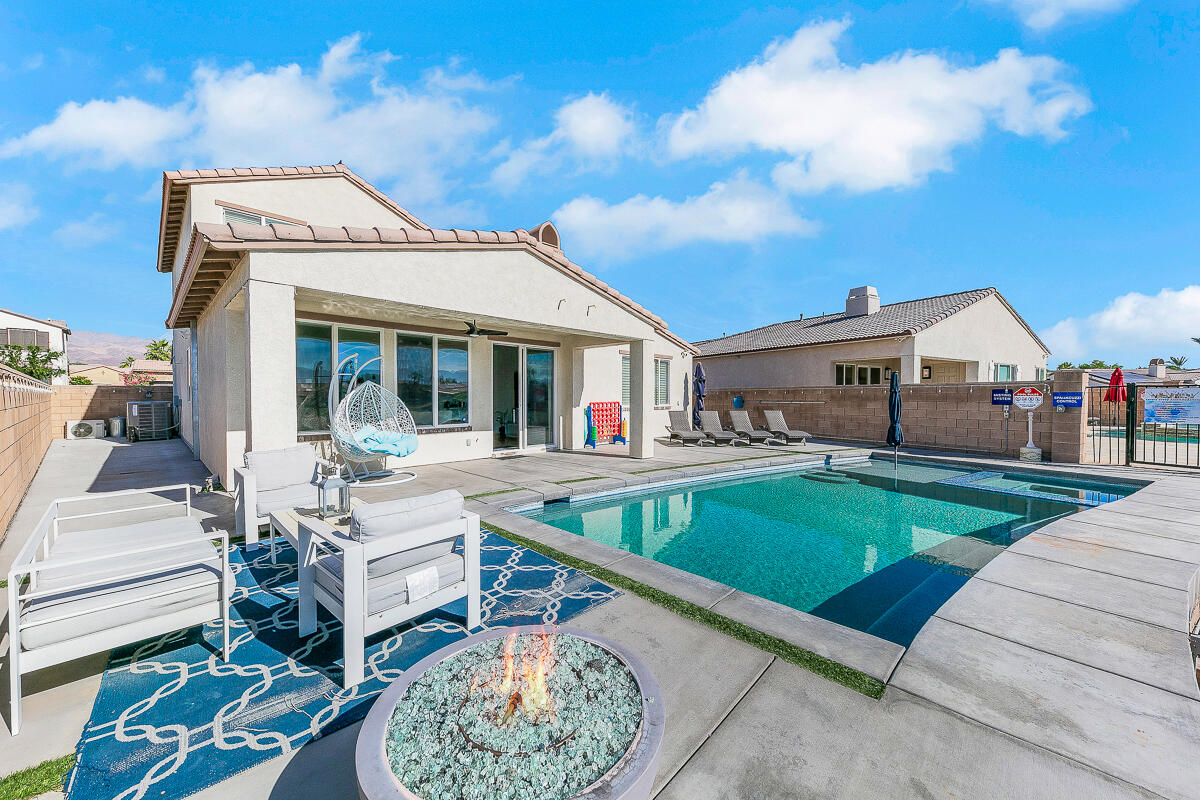 84325 Canzone Drive Indio, CA 92203 - Photo 30 of 53 a front view of house with yard outdoor seating and barbeque oven