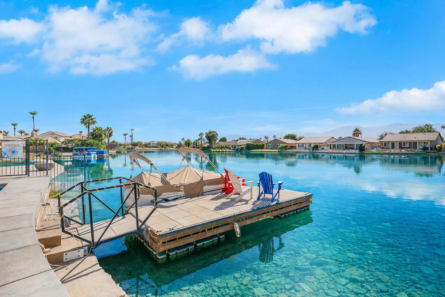 84325 Canzone Drive Indio, CA 92203 - Photo 31 of 53 a wooden bench sitting in the middle of a lake
