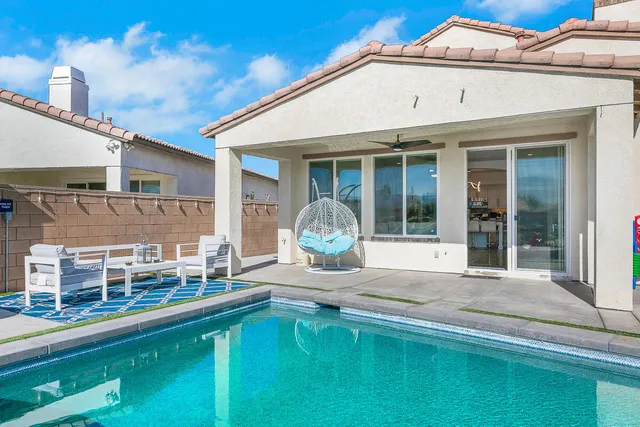 a view of swimming pool with chairs