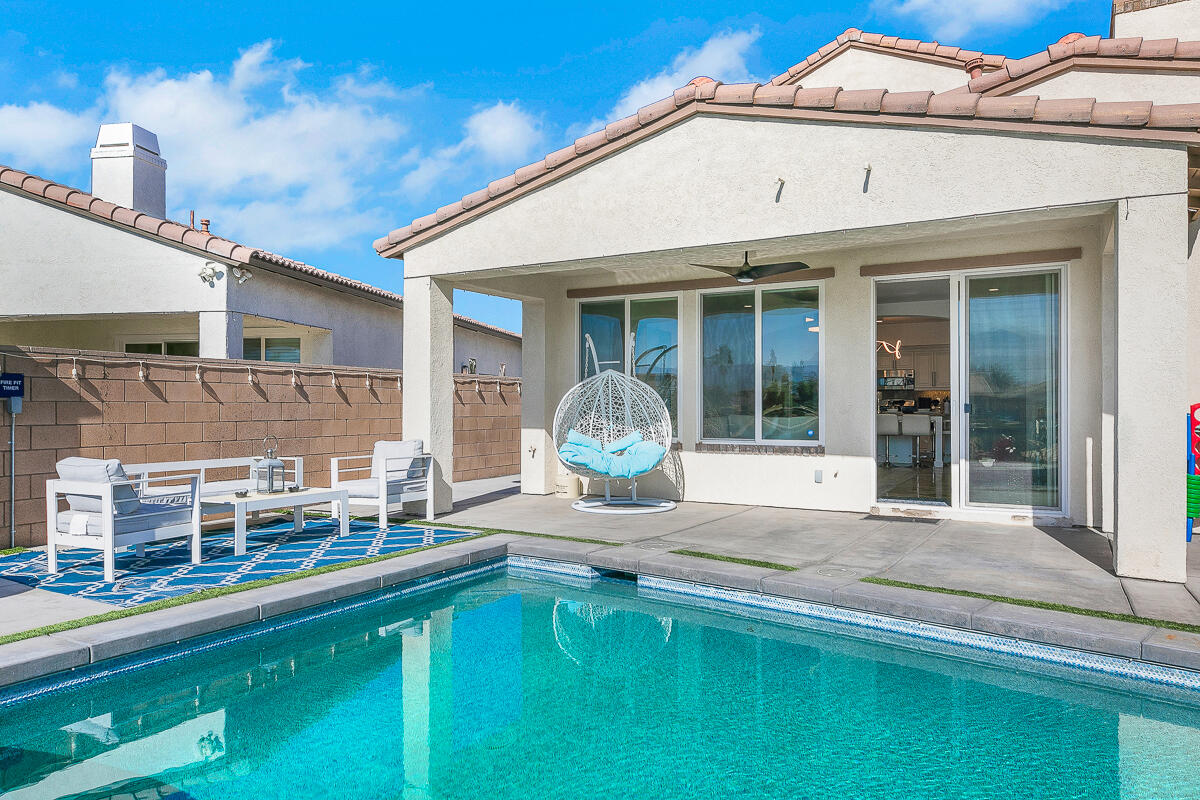 84325 Canzone Drive Indio, CA 92203 - Photo 35 of 53 a front view of a house with table and chairs