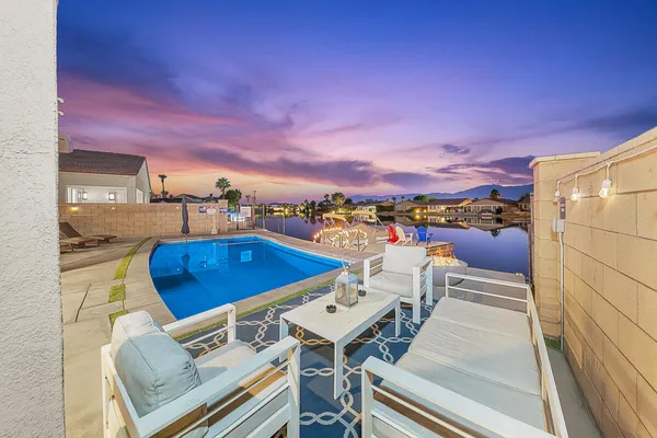 a view of a swimming pool with an outdoor seating