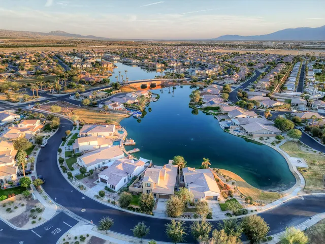 a front view of a house with a yard and potted plants