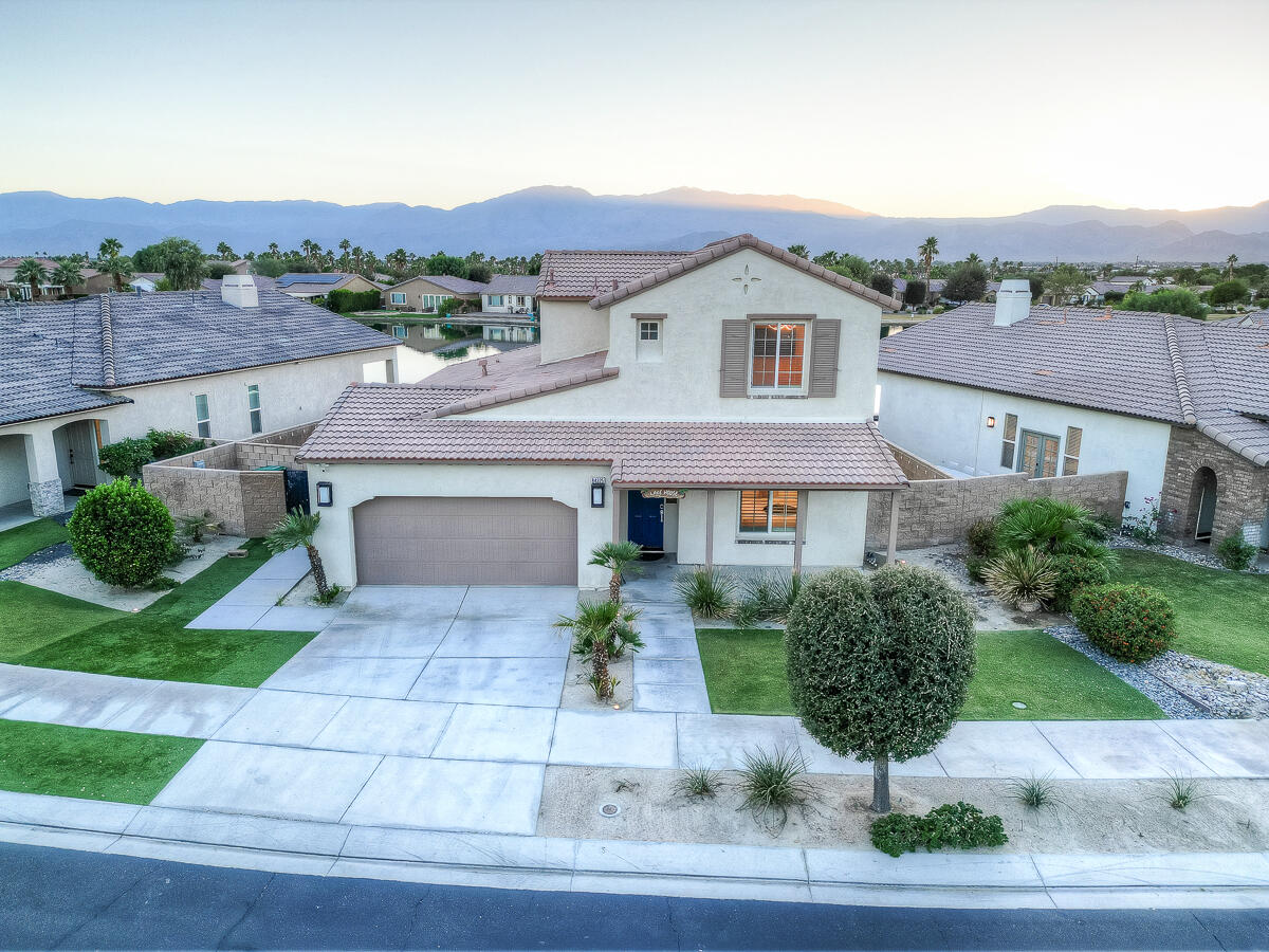 84325 Canzone Drive Indio, CA 92203 - Photo 49 of 53 a front view of a house with a yard and potted plants