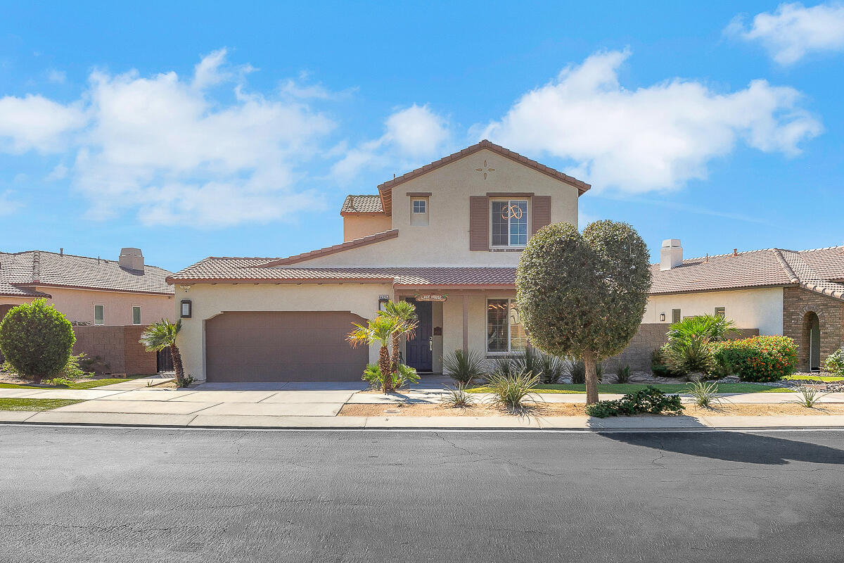 84325 Canzone Drive Indio, CA 92203 - Photo 53 of 53 a front view of a house with a yard and garage