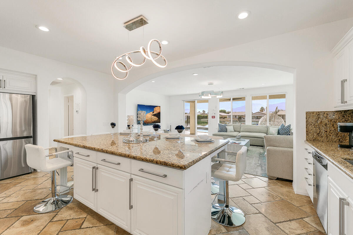 84325 Canzone Drive Indio, CA 92203 - Photo 8 of 53 a kitchen with stainless steel appliances granite countertop a sink and a refrigerator